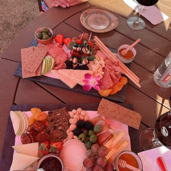 Wine & Rind - a woman sitting at a picnic table - Wine Bars Near Me - Carmel, Indiana
