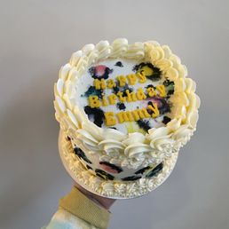 a hand holding a birthday cake a hand holding a birthday cake