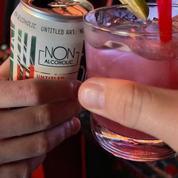  two people toasting with a drink
