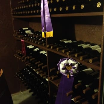 Cliff Creek Cellars in Newberg - a wine rack with wine bottles - Wine Tasting Room Near Me - Newberg, Oregon