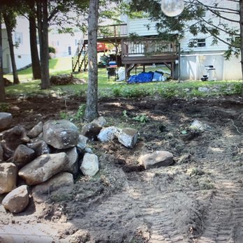 D.S. Landscapes -  a backyard with rocks and trees - Landscaping Near Me