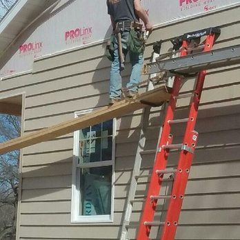 Hope Contracting - a man on a ladder working on a house - General Contractors Near Me - Moberly, Missouri Hope Contracting - a man on a ladder working on a house - General Contractors Near Me - Moberly, Missouri