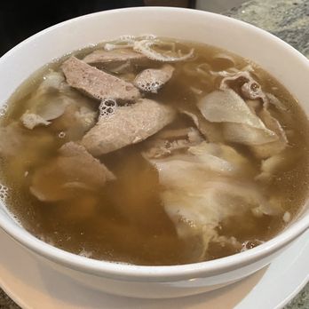 Pho Dinosaur - a bowl of soup on a plate - Vietnamese Near Me - Drumheller, Alberta