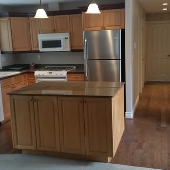 Painting People Plus - a kitchen with wood cabinets and stainless steel appliances - General Contractors Near Me - Edmonds, Washington Painting People Plus - a kitchen with wood cabinets and stainless steel appliances - General Contractors Near Me - Edmonds, Washington