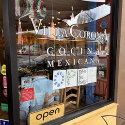 a storefront window with signs in the window a storefront window with signs in the window