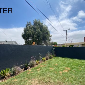 Coastal Painting Design - What a great decision we made to use dark paint on the walls. Same plants, but all the colors pop against this dark backdrop. - Painters Near Me