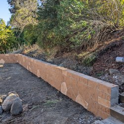 VitaJared Concrete - Retaining wall with concrete and rebar holding it.  Plus a French drain behind it.
