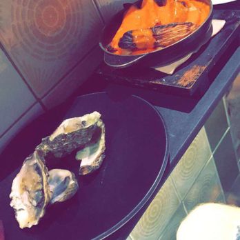 Somorrostro - Oysters with passion fruit and fried potatoes with spicy sauce - Catalan Near Me - Barcelona, B Somorrostro - Oysters with passion fruit and fried potatoes with spicy sauce - Catalan Near Me - Barcelona, B