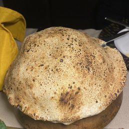 Chicken beryani rice covered with hot baked bread . Looked like giant Mushroom. We first thought it was a mushroom. Chicken beryani rice covered with hot baked bread . Looked like giant Mushroom. We first thought it was a mushroom.