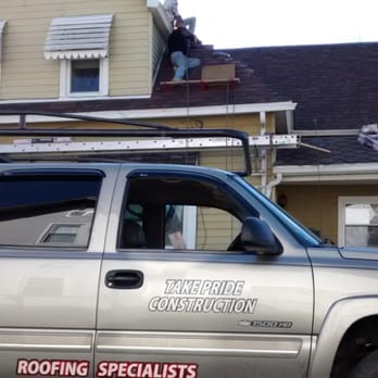 Take Pride Construction - a man on the roof of a house - Roofing Near Me - Peru, Indiana Take Pride Construction - a man on the roof of a house - Roofing Near Me - Peru, Indiana