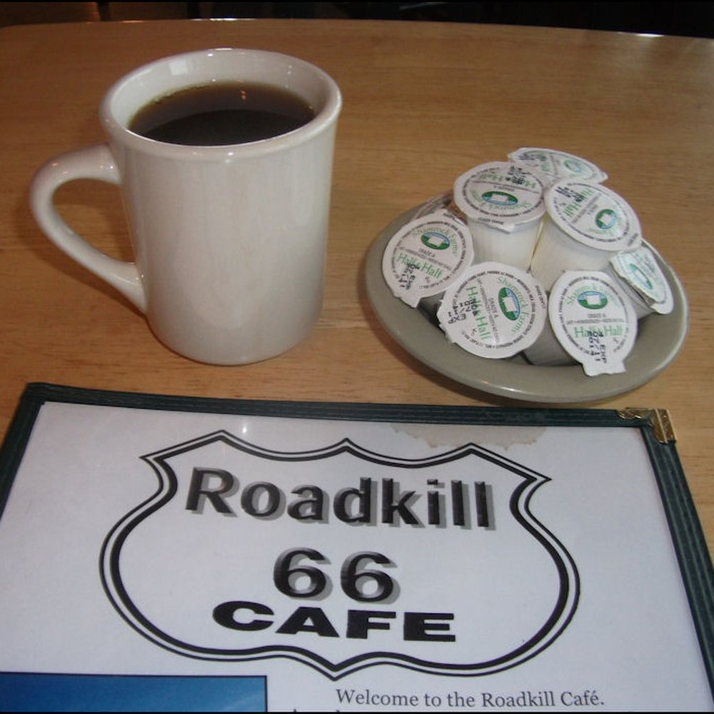 The Roadkill Cafe - I could not resist snapping this classic photo, which includes the classic menu, coffee, and artfully stacked creamer. - American Near Me - Seligman, Arizona The Roadkill Cafe - I could not resist snapping this classic photo, which includes the classic menu, coffee, and artfully stacked creamer. - American Near Me - Seligman, Arizona