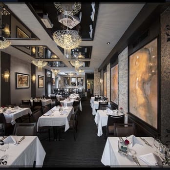Giovanni's - a dining room with tables, chairs, and chandeliers - Italian Near Me - Ottawa, Ontario