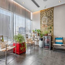 Zen Health Center - Waiting area with calming tones and wellness drinks on demand.