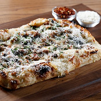 P.Za Kitchen - a pizza on a cutting board - Food Delivery Services Near Me P.Za Kitchen - a pizza on a cutting board - Food Delivery Services Near Me
