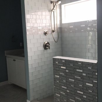 Zimmerle Floors - Glass tile shower with stainless steal accents. - Flooring Near Me - Clute, Texas