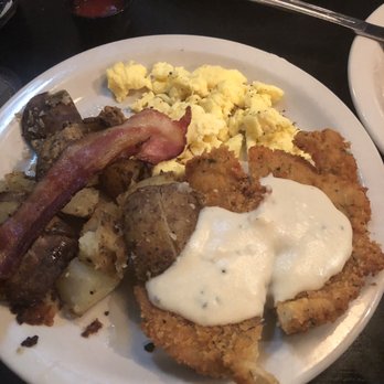 District 7 Grill - Chicken fried chicken with White gravy, bacon, potatoes and eggs - Breakfast & Brunch Near Me - Houston, Texas District 7 Grill - Chicken fried chicken with White gravy, bacon, potatoes and eggs - Breakfast & Brunch Near Me - Houston, Texas