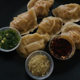 Steamed Chicken Dumplings with minced jalapeño, ginger and red pepper oil. Steamed Chicken Dumplings with minced jalapeño, ginger and red pepper oil.