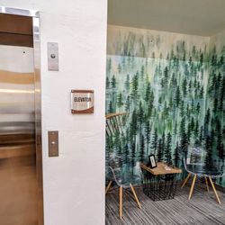 The Grand Cloudcroft Hotel - Cool seating area by the lift. The wall paper is actually a hiking area nearby
