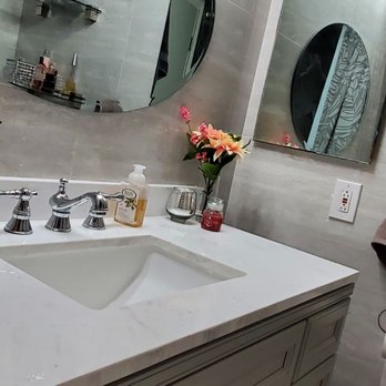 Sopling - a bathroom with a sink and a large mirror - Flooring Near Me - Canoga Park, California Sopling - a bathroom with a sink and a large mirror - Flooring Near Me - Canoga Park, California