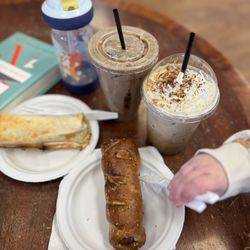 The Farmhouse Coffee Exchange - Breakfast burrito, pretzel wrapped sausage, tiramisu cold brew with whip cream, brown cow iced latte and a very happy toddler