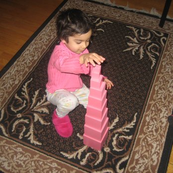 Peace Montessori - child working wtih montessori pink tower - Preschools Near Me - Morton Grove, Illinois Peace Montessori - child working wtih montessori pink tower - Preschools Near Me - Morton Grove, Illinois