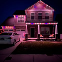 Stillman Solutions - House with Permanent Holiday Lighting installed, displaying Red, White, and Blue lighting pattern.