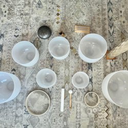 Sound healing tools, including crystal singing bowls, chimes, used in sessions to promote relaxation and balance.