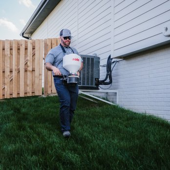 Scott's Pest Control - Putting down a granular treatment to help with a tick issue - Pest Control Near Me