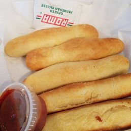 a basket of breadsticks and ketchup a basket of breadsticks and ketchup