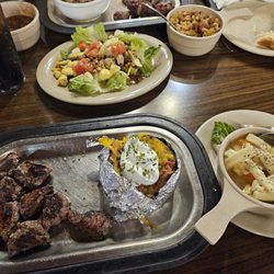 Hoss's Steak & Sea House - Steak tips with a loaded baked potato. and salad bar.
