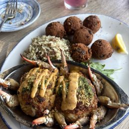 Crab cake with dirty rice and hush puppies Crab cake with dirty rice and hush puppies