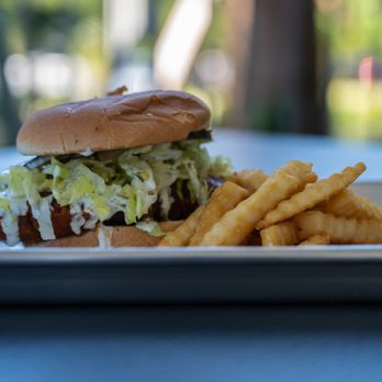 Redefined Food - Hot Chicken Sandwich topped with house ranch and buffalo sauce and served with a side of fries - Food Delivery Services Near Me - Palm Coast, Florida