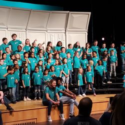South Shore Children's Chorus - Ms.Oberoi with students on stage