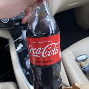 Firehouse Subs - a hand holding a bottle of coke - Fast Food Near Me - Provo, Utah
