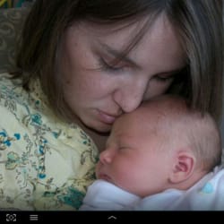 Nurture Doula Services - Abbie holding her newborn daughter during her stay in the NICU. Photo was taken as they awaited to get released.