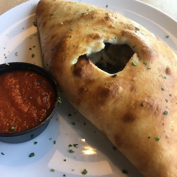 Dewey's Pizza - O'Fallon - Calzone stuffed with sausage spinach and mushrooms in addition to mozz cheese and ricotta! - Pizza Near Me - O'fallon, Illinois