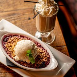 Seasonal Crumble: A Traditional Scottish Favorite; house-made oat crumble, served hot, topped with vanilla bean ice cream