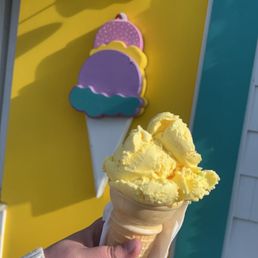 a hand holding a cone of ice cream a hand holding a cone of ice cream