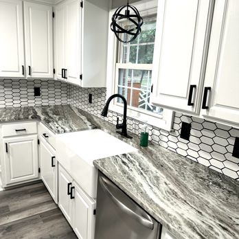 Romero Trade Partners - a kitchen with white cabinets and marble countertops - General Contractors Near Me Romero Trade Partners - a kitchen with white cabinets and marble countertops - General Contractors Near Me