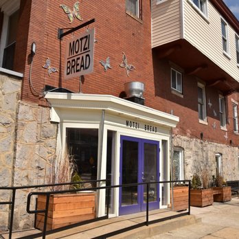 Motzi Bread - a brick building with a blue door - Bakeries Near Me - Baltimore, Maryland