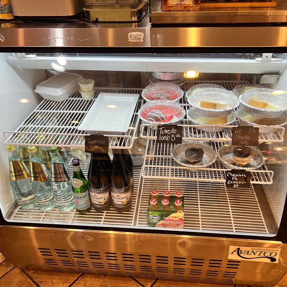 Their dessert case with sparkling water Their dessert case with sparkling water