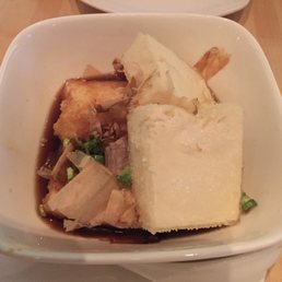 Agedashi tofu: fried tofu in a light sauce, topped with scallion and dashi flakes Agedashi tofu: fried tofu in a light sauce, topped with scallion and dashi flakes