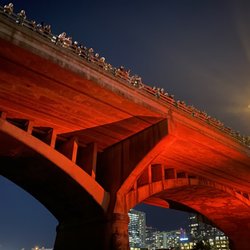 Live Love Paddle Austin Kayak Tours and Rentals - Bat bridge with red light.