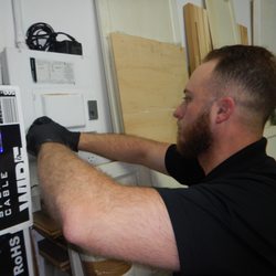 Diversified Home Inspections - Chris inspecting an electrical panel at a commercial property