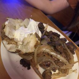 Sirloin with mushrooms and onions and a side of baked potato Sirloin with mushrooms and onions and a side of baked potato