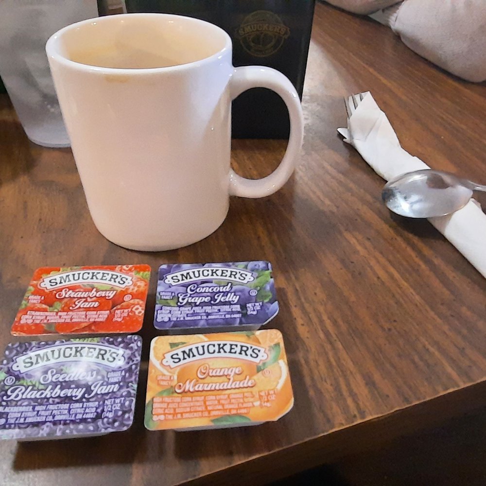 Warwick Restaurant - a cup of coffee, packets of mucklers, and a spoon on a table - Breakfast & Brunch Near Me - Newport News, Virginia Warwick Restaurant - a cup of coffee, packets of mucklers, and a spoon on a table - Breakfast & Brunch Near Me - Newport News, Virginia