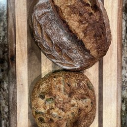 Side by side of olive loaf and sourdough