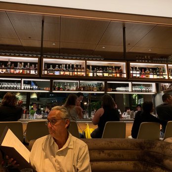 Stripsteak - Full bar at the center of the restaurant & live music in the corner - Steakhouses Near Me - Honolulu, Hawaii