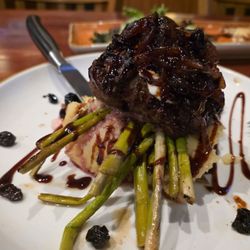 Double Eagle Steak & Seafood - Sirloin on a mountain of mashed potatoes and  asparagus. Onions on top with secret cheese underneath. $55-57.