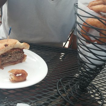 Jaspers Cafe - Half of a burger (with bacon, tomato, chipotle sauce and barbecue sauce) and onion rings. - Burgers Near Me - Medford, Oregon